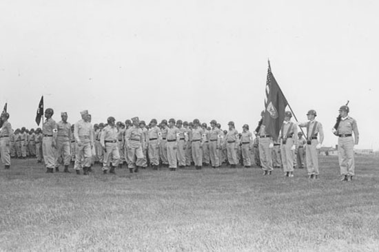 Ed in honor guard holding Division Colors.
